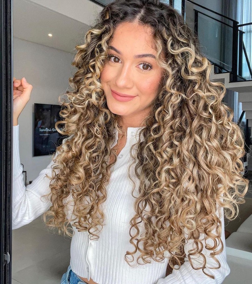 luzes mel dourado em cabelo cacheado