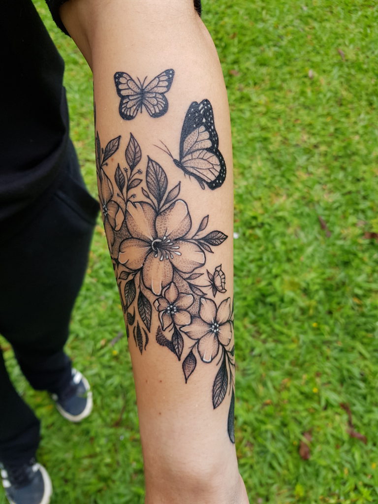 tatuagem feminina braço com flores pequenas