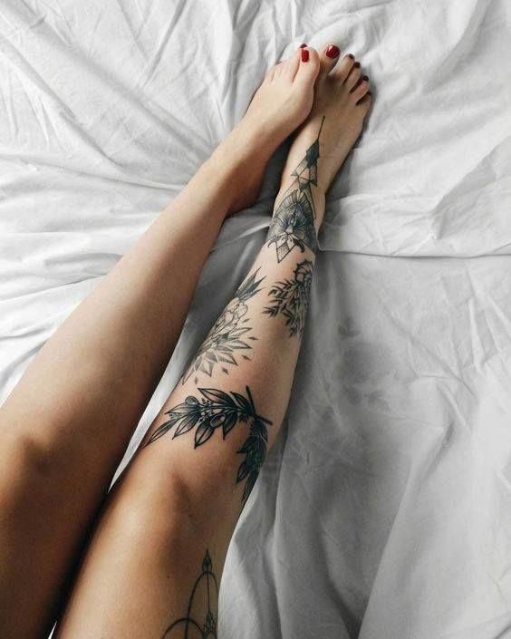 tatuagem feminina na lateral da perna com flores