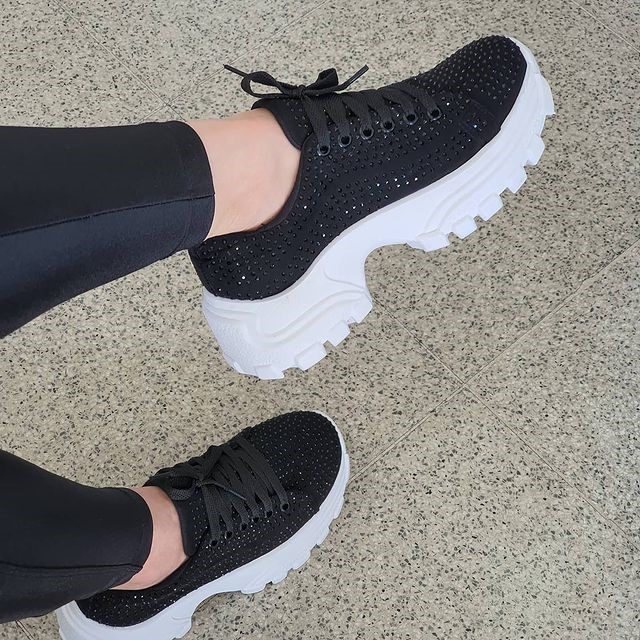 visual elegante com tenis e saia midi