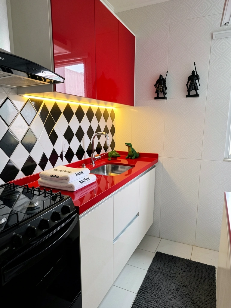Cozinha com papel de parede floral, bancada de mármore e armários brancos, iluminação natural.