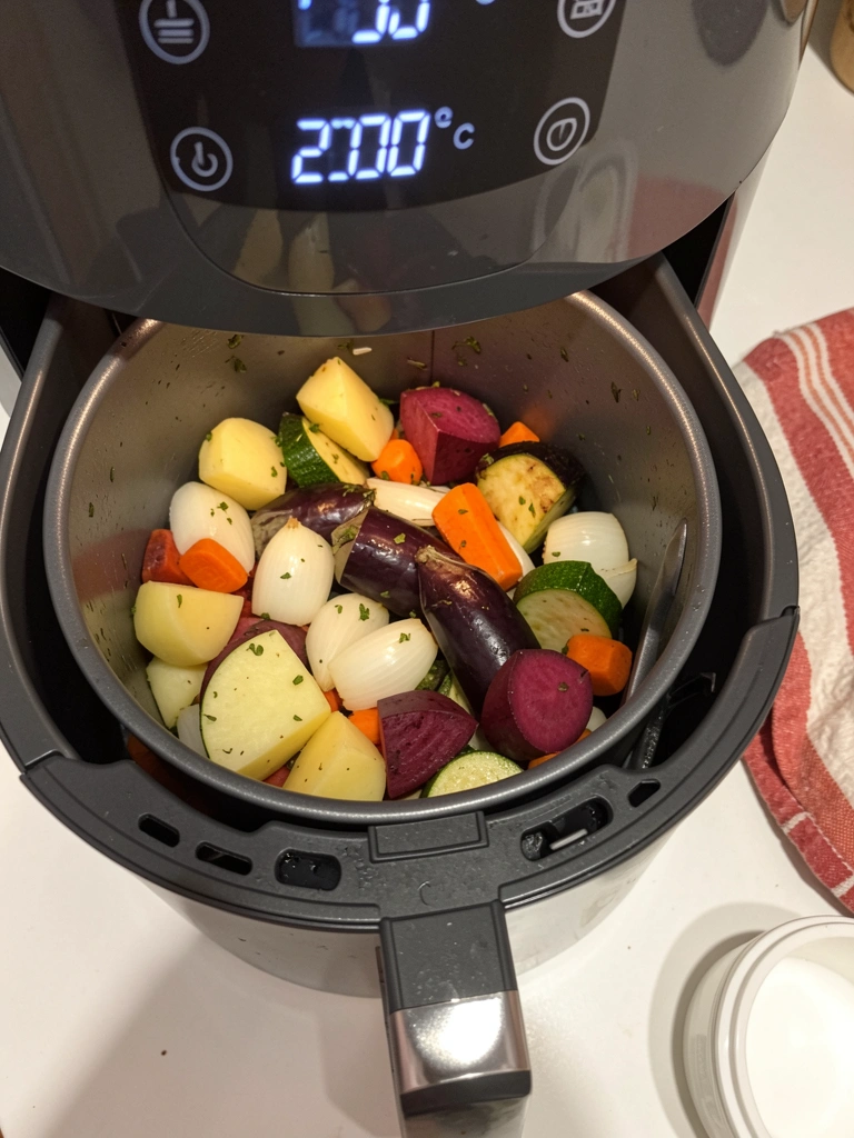 Airfryer ligada com luz interna acesa, painel digital exibindo 200°C.